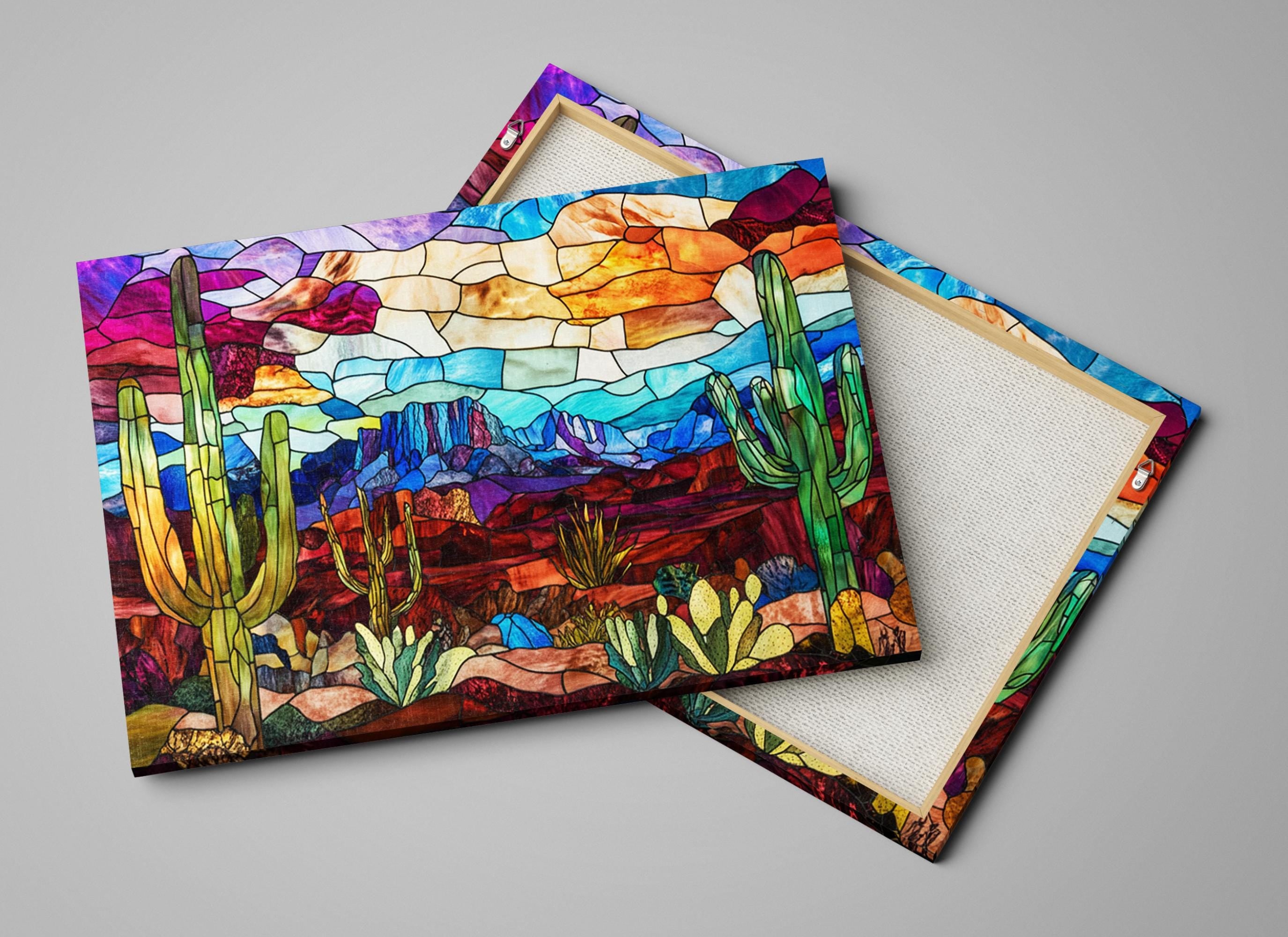 a pair of coasters with a painting of a desert scene