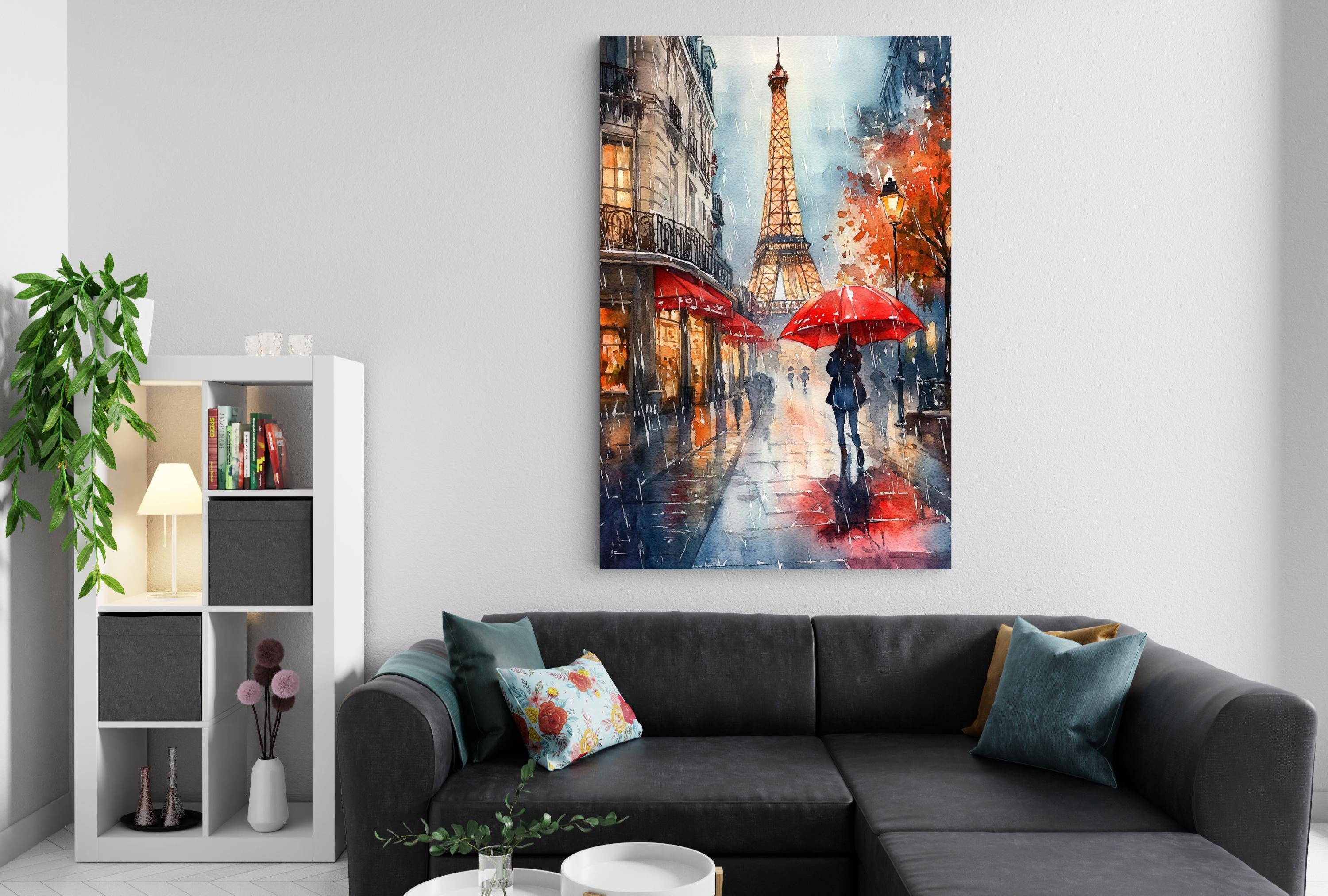 a cozy living room with a gray sectional sofa, a white bookshelf, and a large painting of the Eiffel Tower and a person walking with an umbrella.