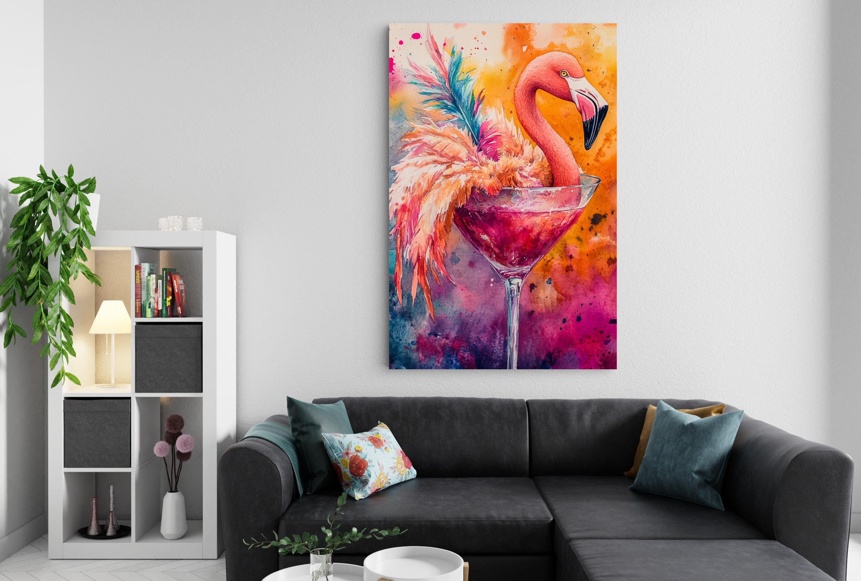 a vibrant painting of a flamingo perched on a martini glass, set against a colorful background. The painting is hung on a white wall above a gray couch, which is adorned with throw pillows and a vase of flowers.