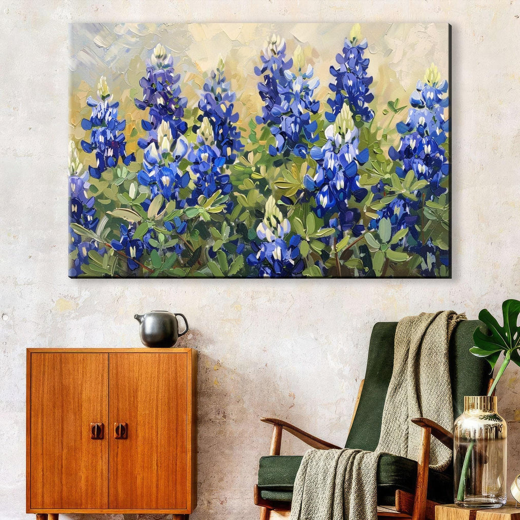 a large painting of blue flowers hanging on a wall above a wooden cabinet and a green armchair in a living room setting.