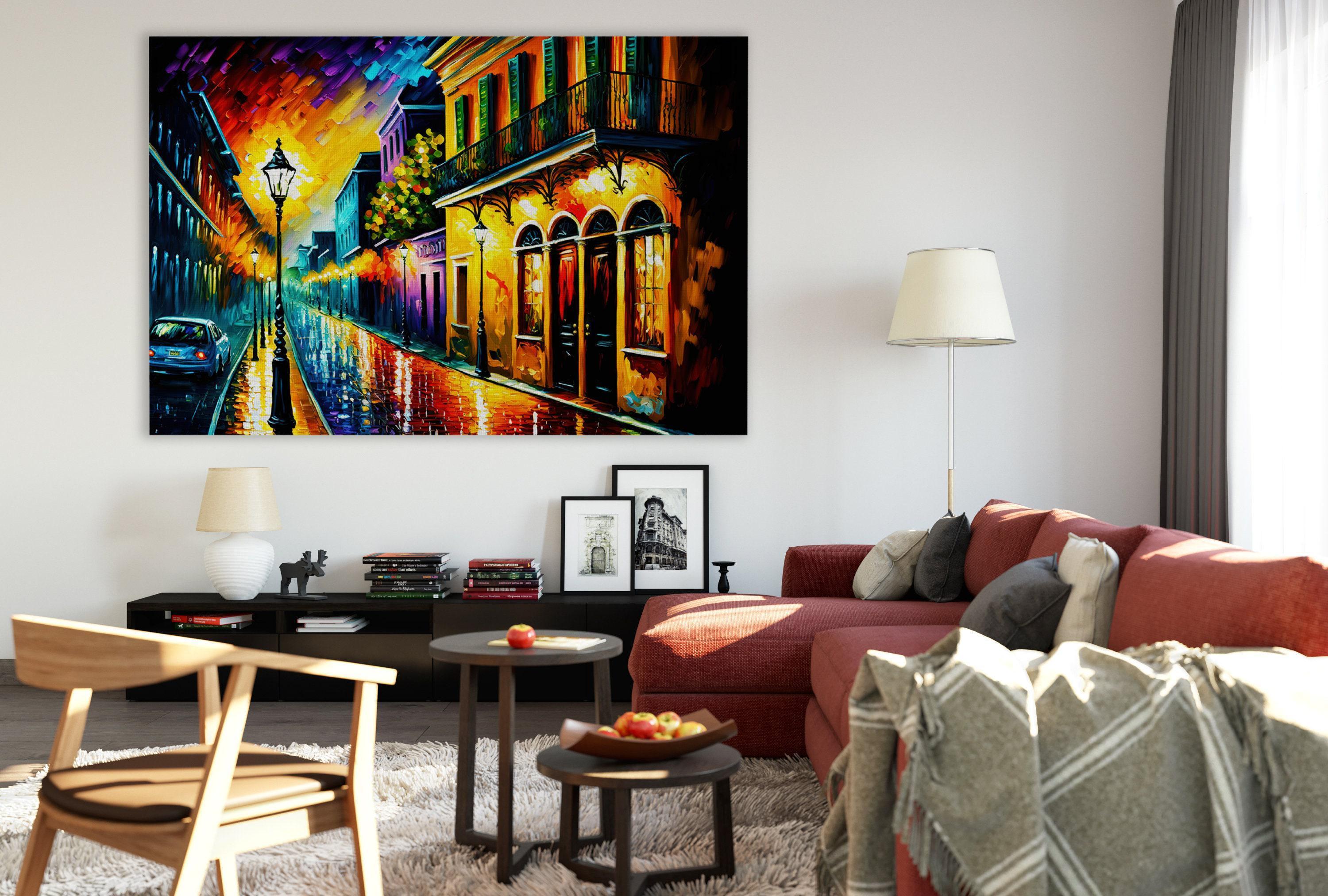 a modern living room with a large, colorful painting of a city street hanging on the wall. The room is furnished with a red sofa, a wooden chair, and a coffee table with a bowl of fruit. The overall decor has a contemporary and stylish feel.