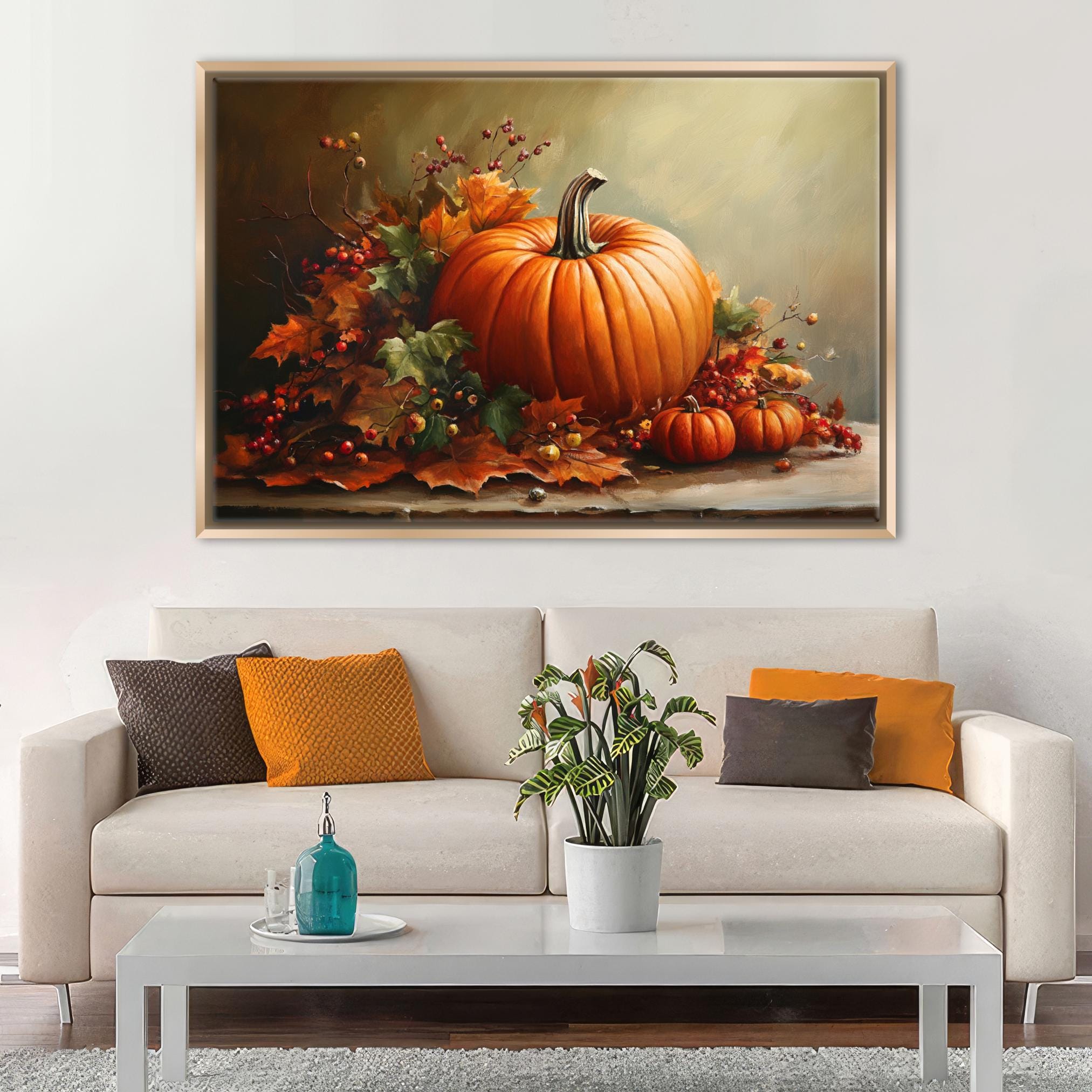 a large painting of a pumpkin and autumn leaves hanging on a wall above a white sofa with colorful throw pillows.