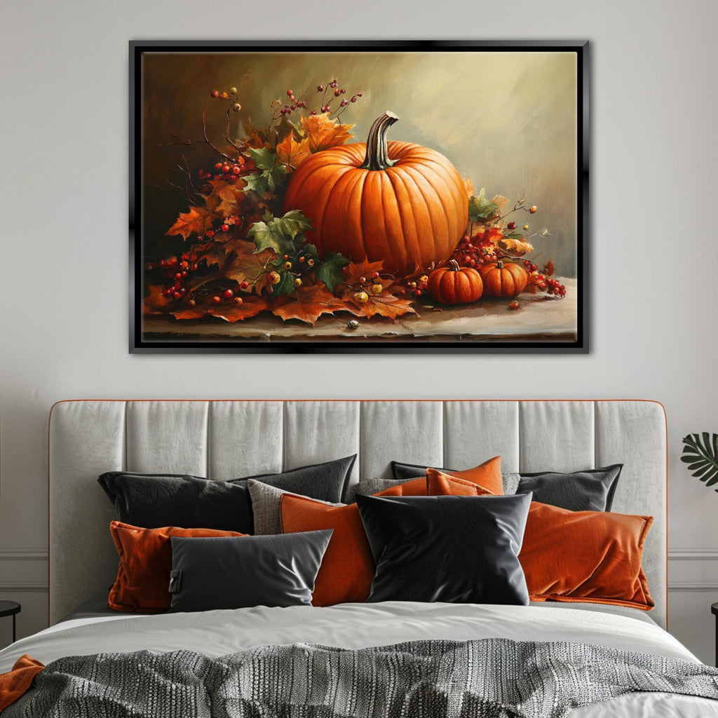 a large framed painting of a pumpkin and autumn leaves hanging above a bed with a gray headboard and black and orange pillows.