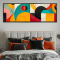 a bedroom with a large painting above the bed