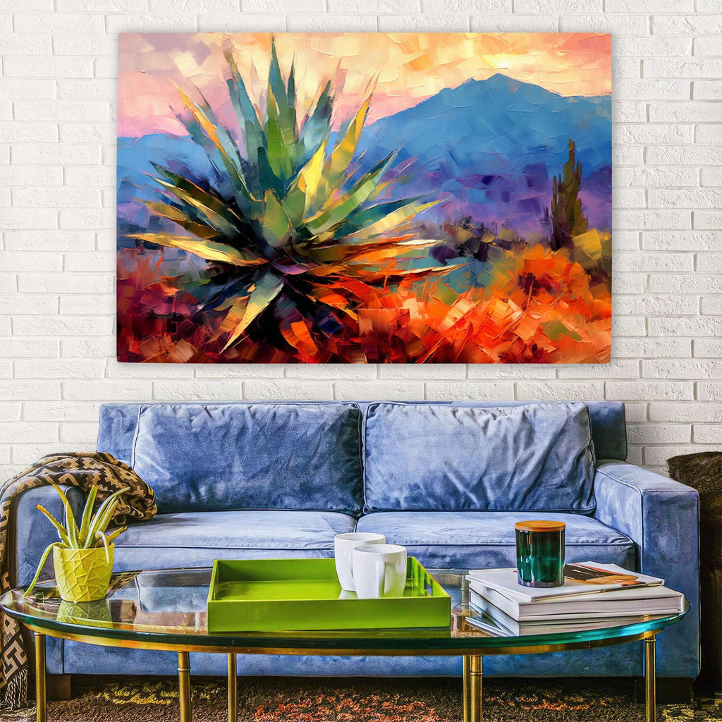a vibrant painting of a desert landscape with a large cactus in the foreground, hanging on a white brick wall above a blue couch. The couch is positioned in front of a glass coffee table, which holds a few items such as a green tray, a cup, and a book.
