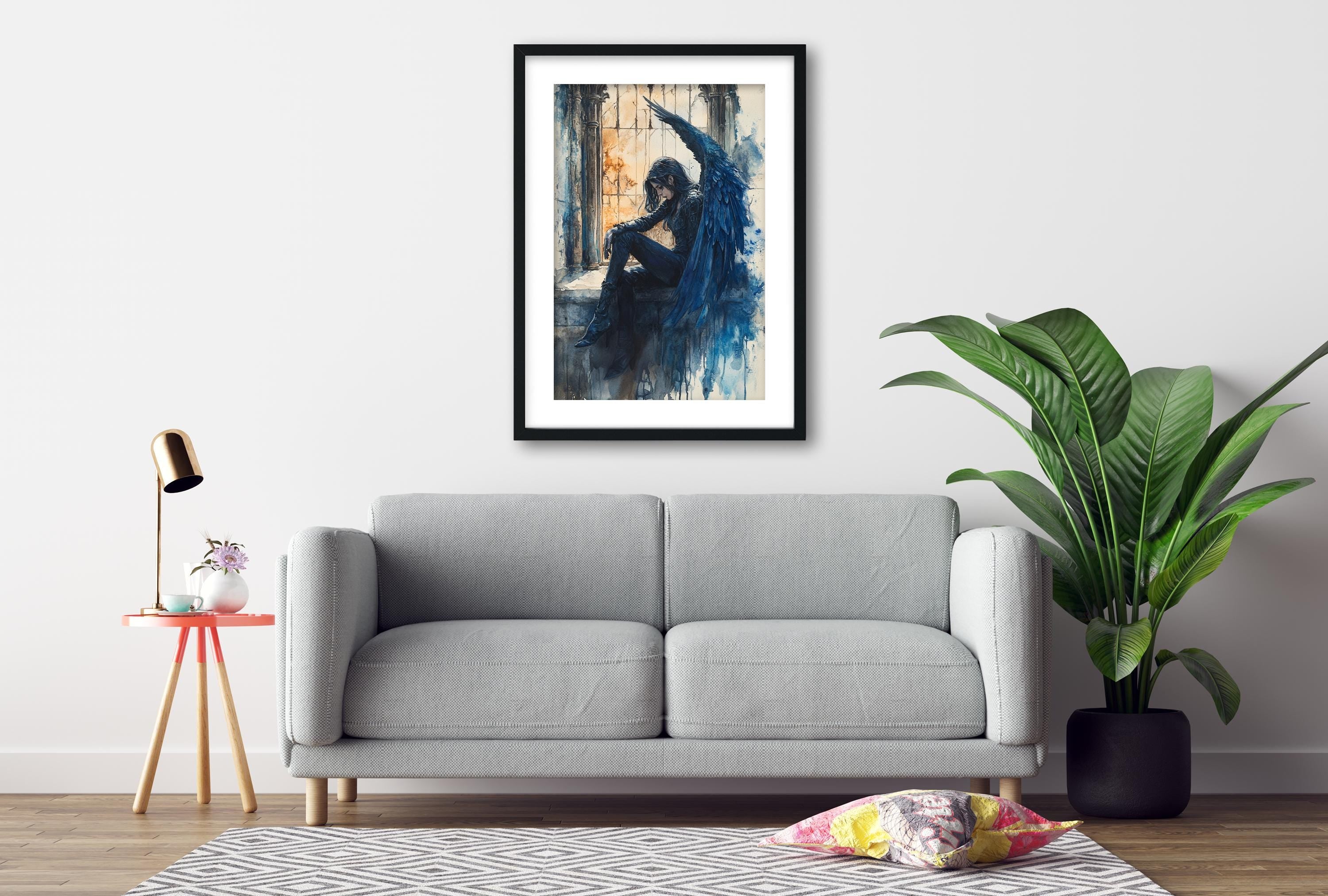 a gray sofa, a framed painting of a woman with a blue background, a potted plant, and a small table with a lamp.