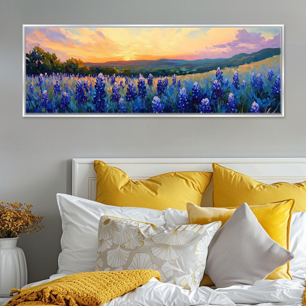 a painting of a field of wildflowers on a wall above a bed