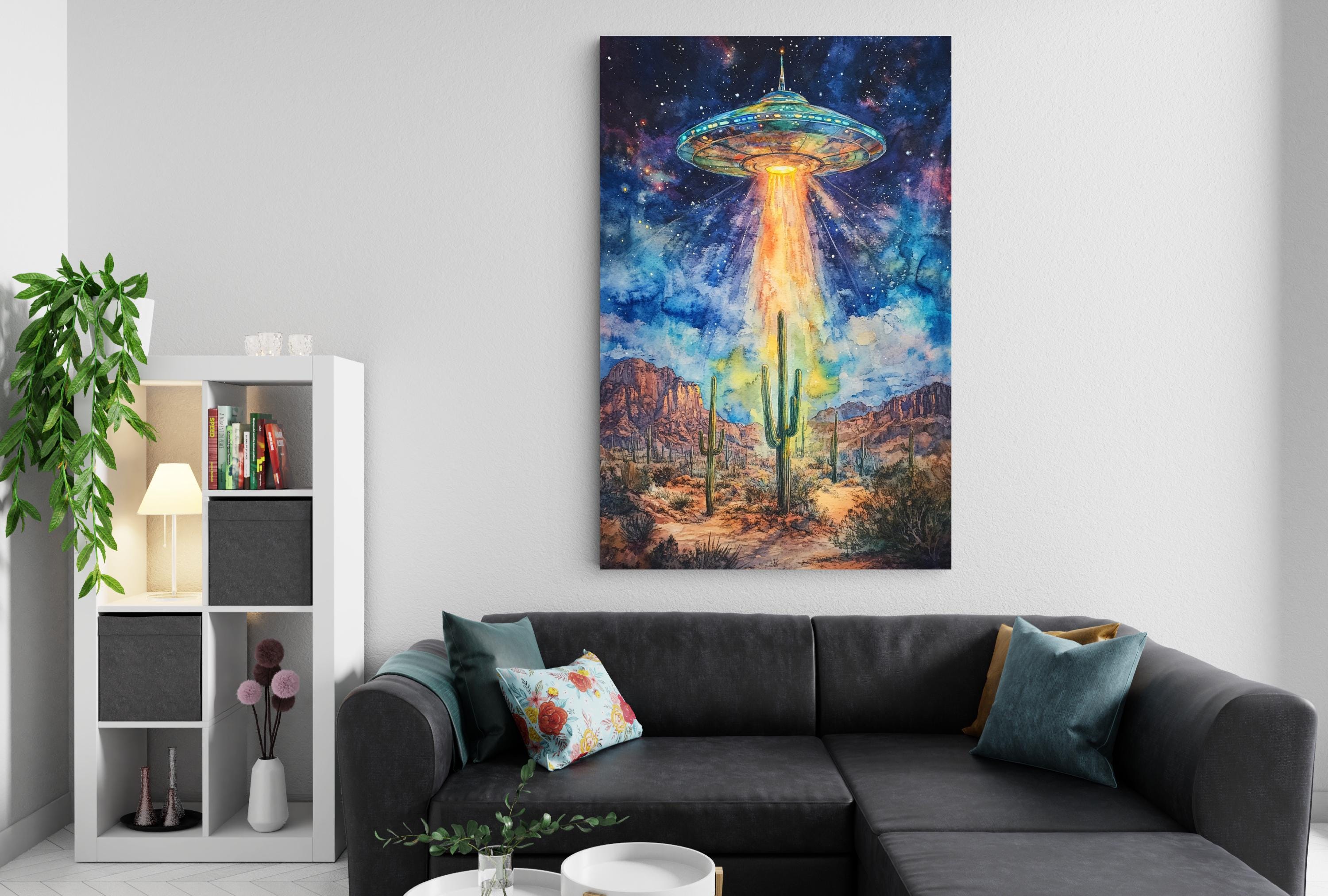 a large, colorful painting of an alien spacecraft hovering over a desert landscape, with mountains and cacti in the background.