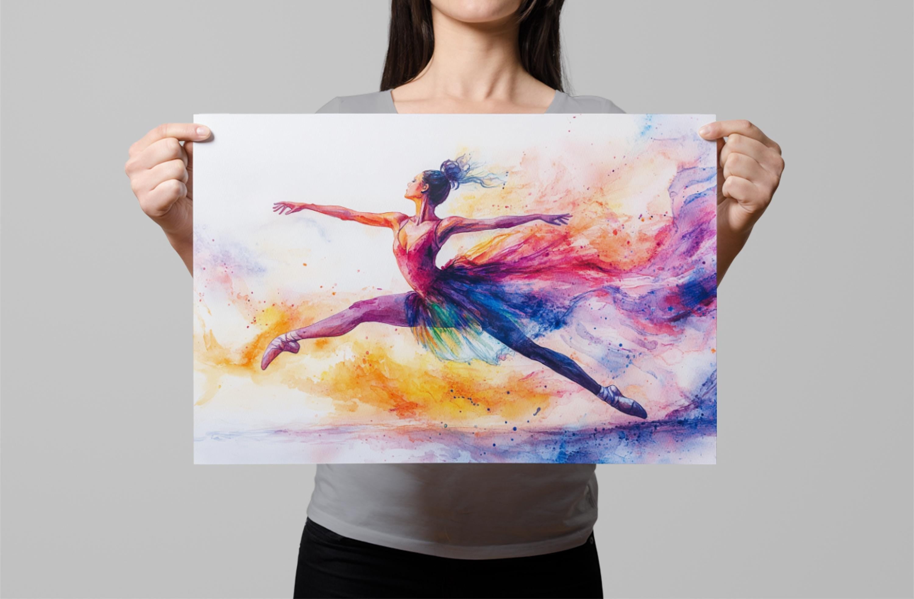 A woman is holding up a colorful painting of a ballerina in mid-jump, with vibrant splashes of color surrounding her.