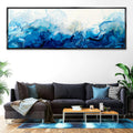 a living room with a couch and a painting on the wall