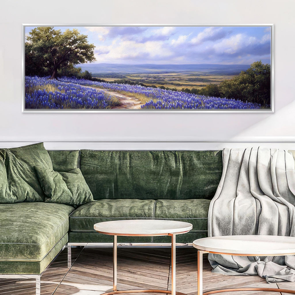 a living room with a green couch and a painting on the wall