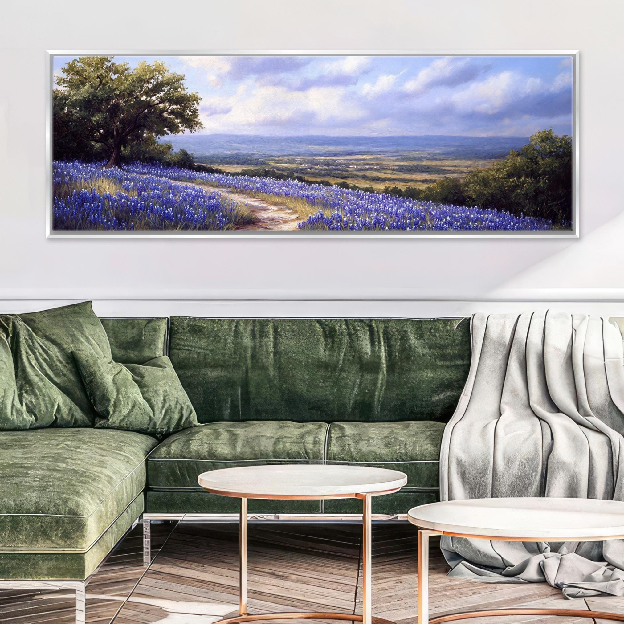 a living room with a green couch and a painting on the wall