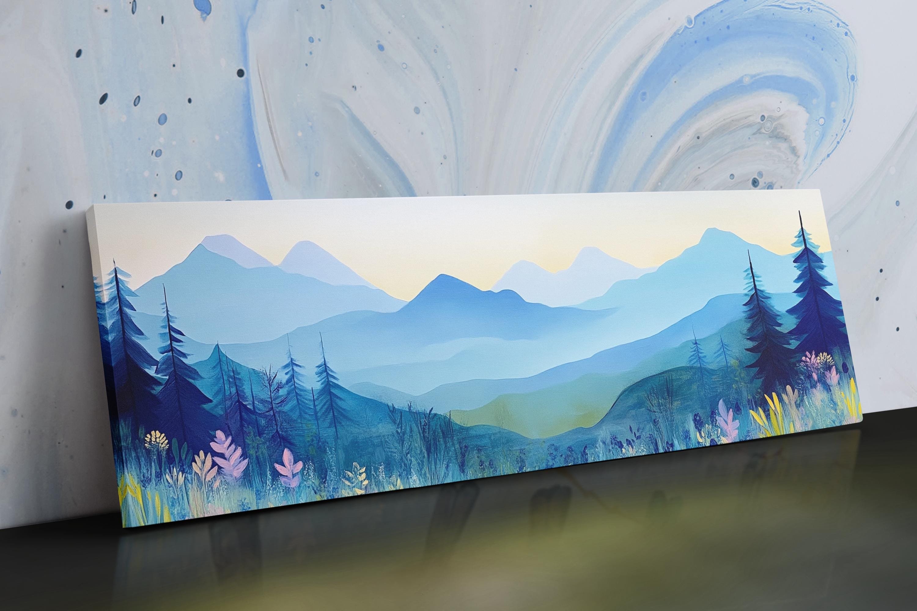 a painting of mountains and trees on a table