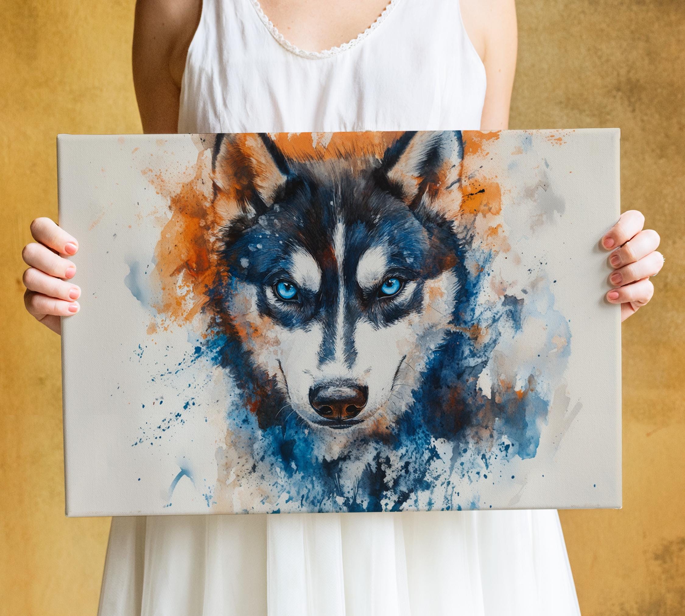 A person is holding a canvas print of a painting of a blue and white husky dog with striking blue eyes.