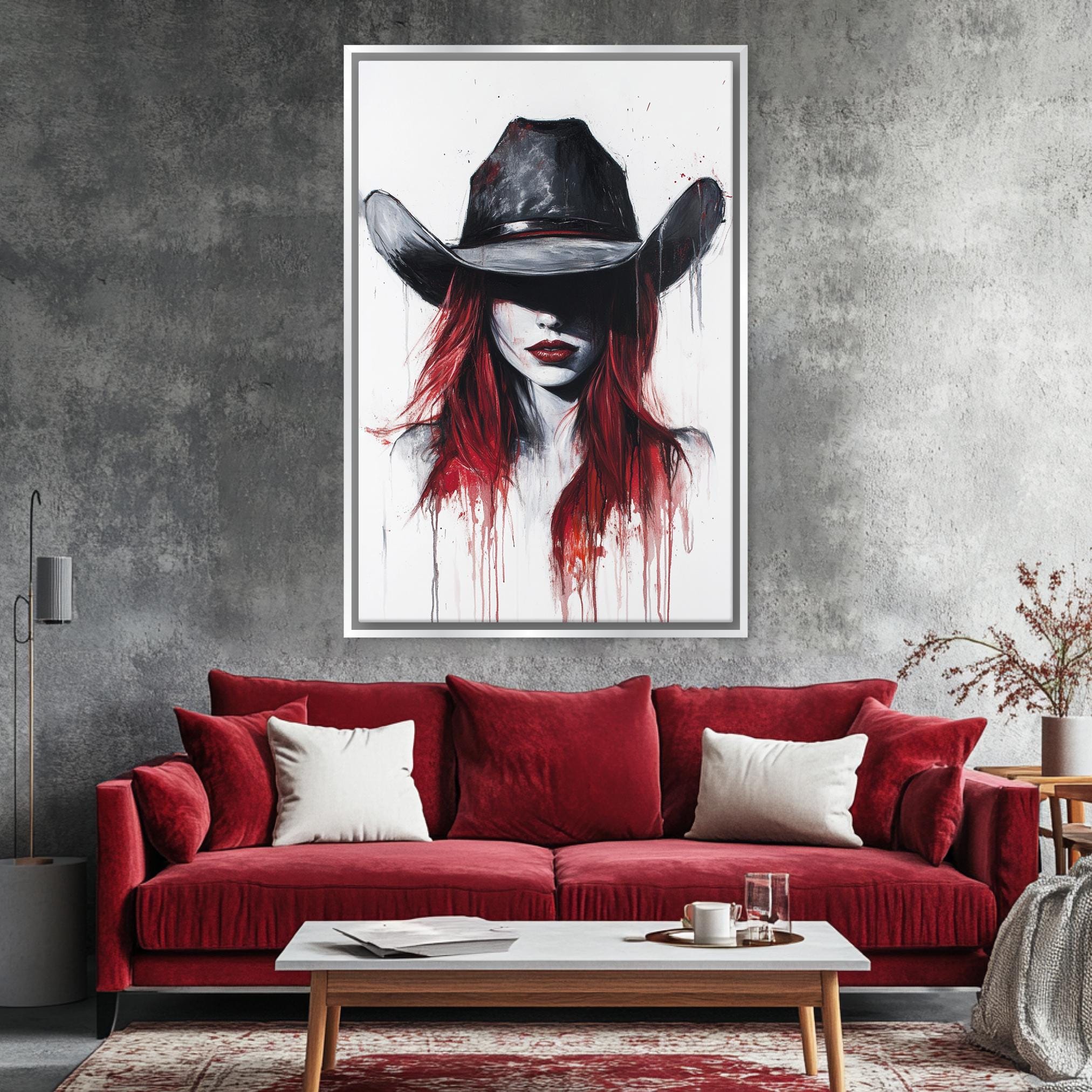 a living room with a red couch and a painting on the wall