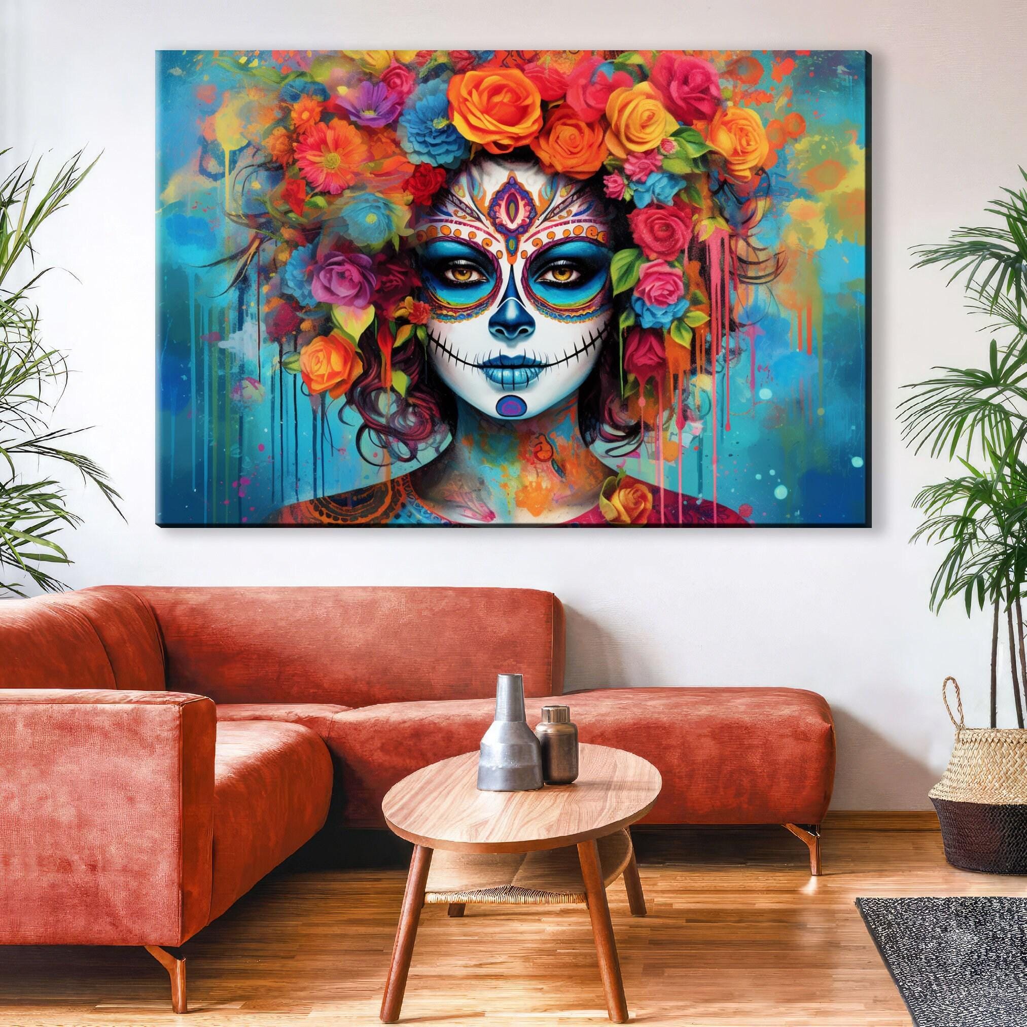 a large, colorful painting of a woman's face with a sugar skull design, hanging on a wall above a red couch in a living room setting.