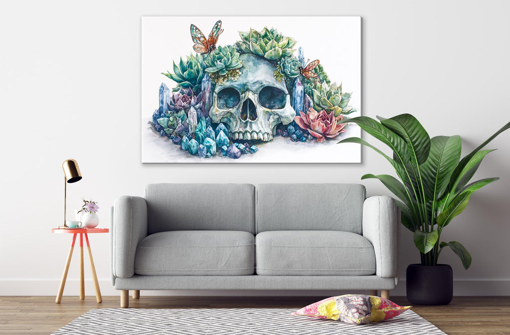 a gray sofa, a potted plant, a lamp, and a painting of a skull surrounded by colorful flowers and plants on the wall.