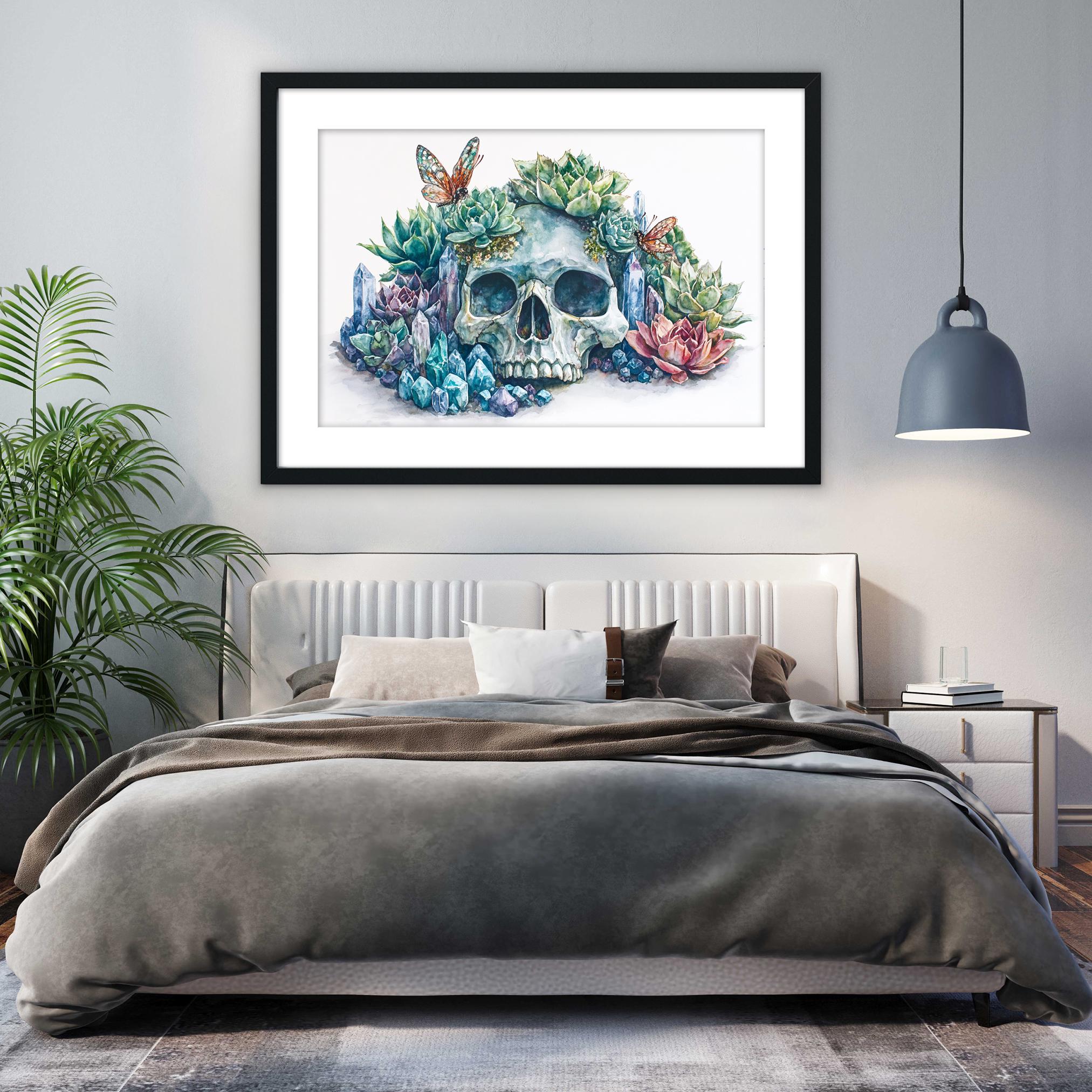 a bedroom with a large bed, a framed artwork of a skull surrounded by colorful plants and flowers, and a pendant light hanging above the bed.