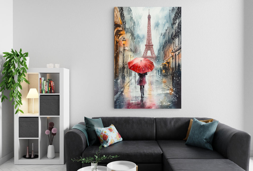 a cozy living room with a black sectional sofa, a bookshelf, and a large painting of a woman walking with a red umbrella in front of the Eiffel Tower.