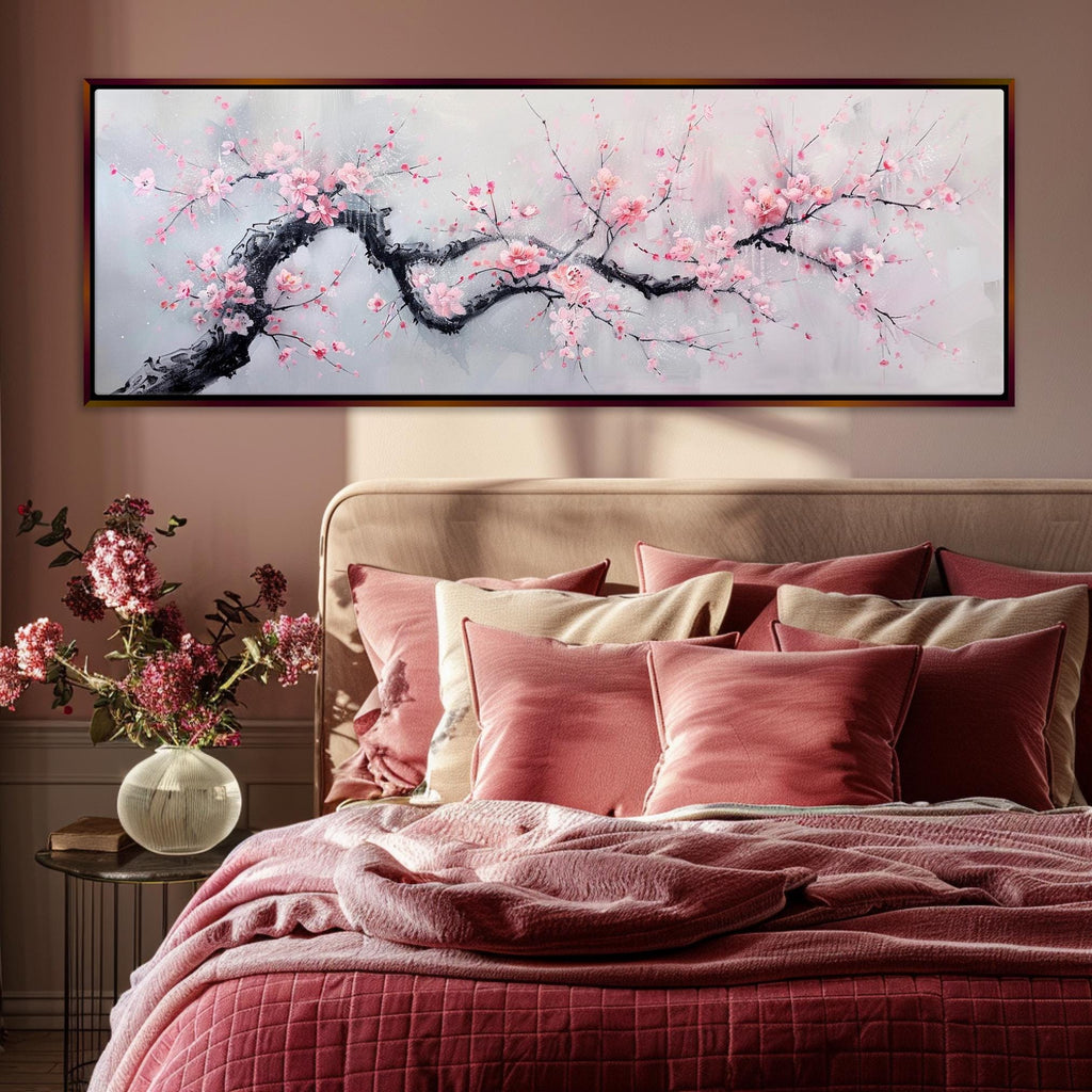 a bed with a pink comforter and a painting on the wall