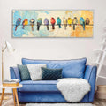 a blue couch with white throw pillows, a white shag rug, and a white fur throw. Above the couch, there is a large painting of colorful birds perched on a wire.