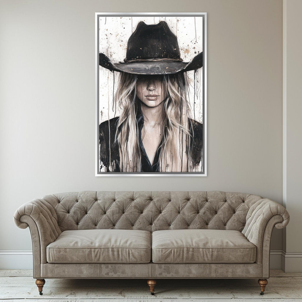 a living room with a couch and a painting of a woman wearing a cowboy hat