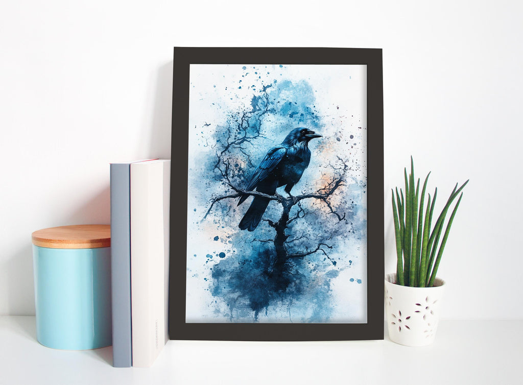 a framed painting of a black bird perched on a branch, surrounded by splashes of blue and white paint, creating a striking and artistic composition.