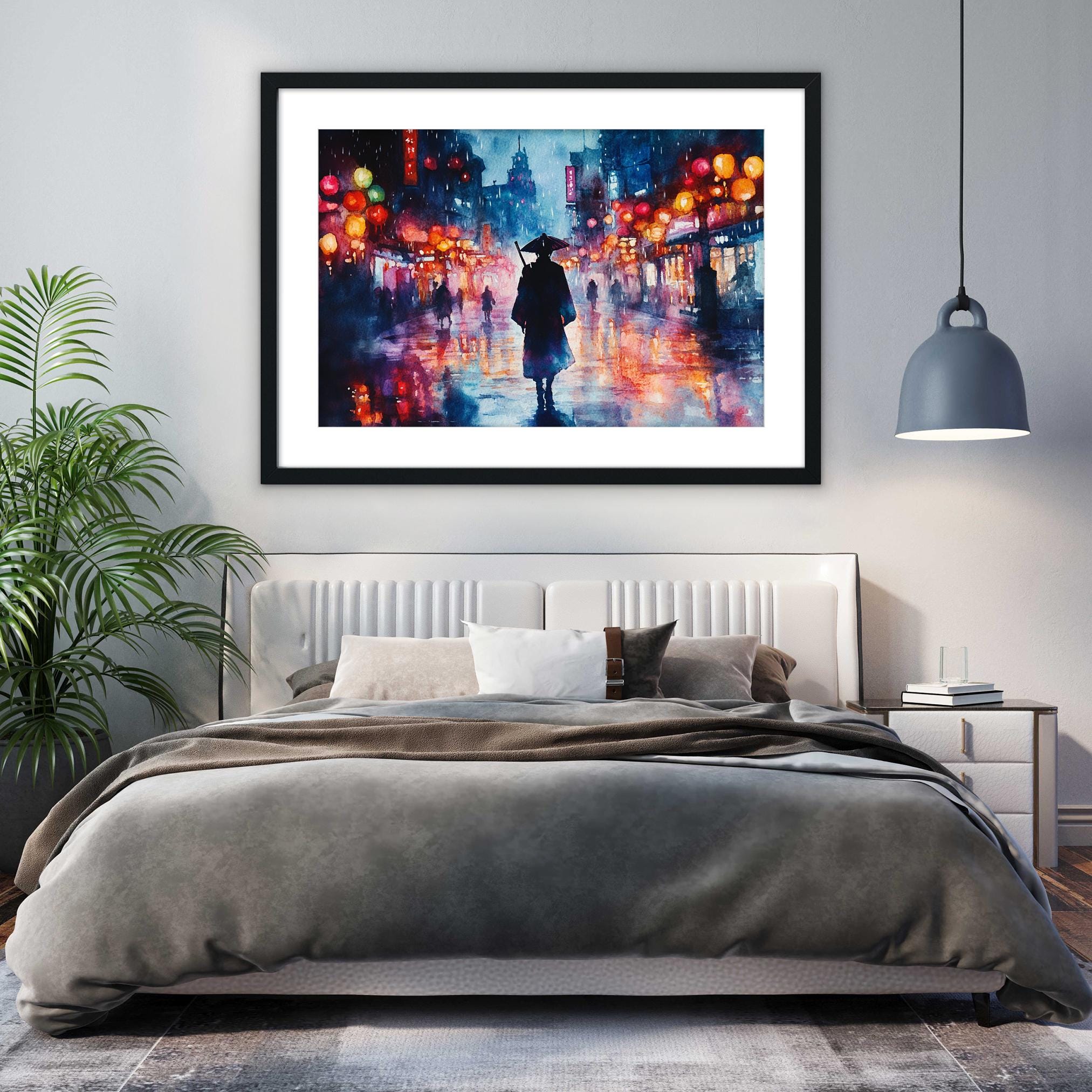 a bedroom with a large bed, a framed painting of a person walking on a city street at night, and a potted plant on the left side of the room.