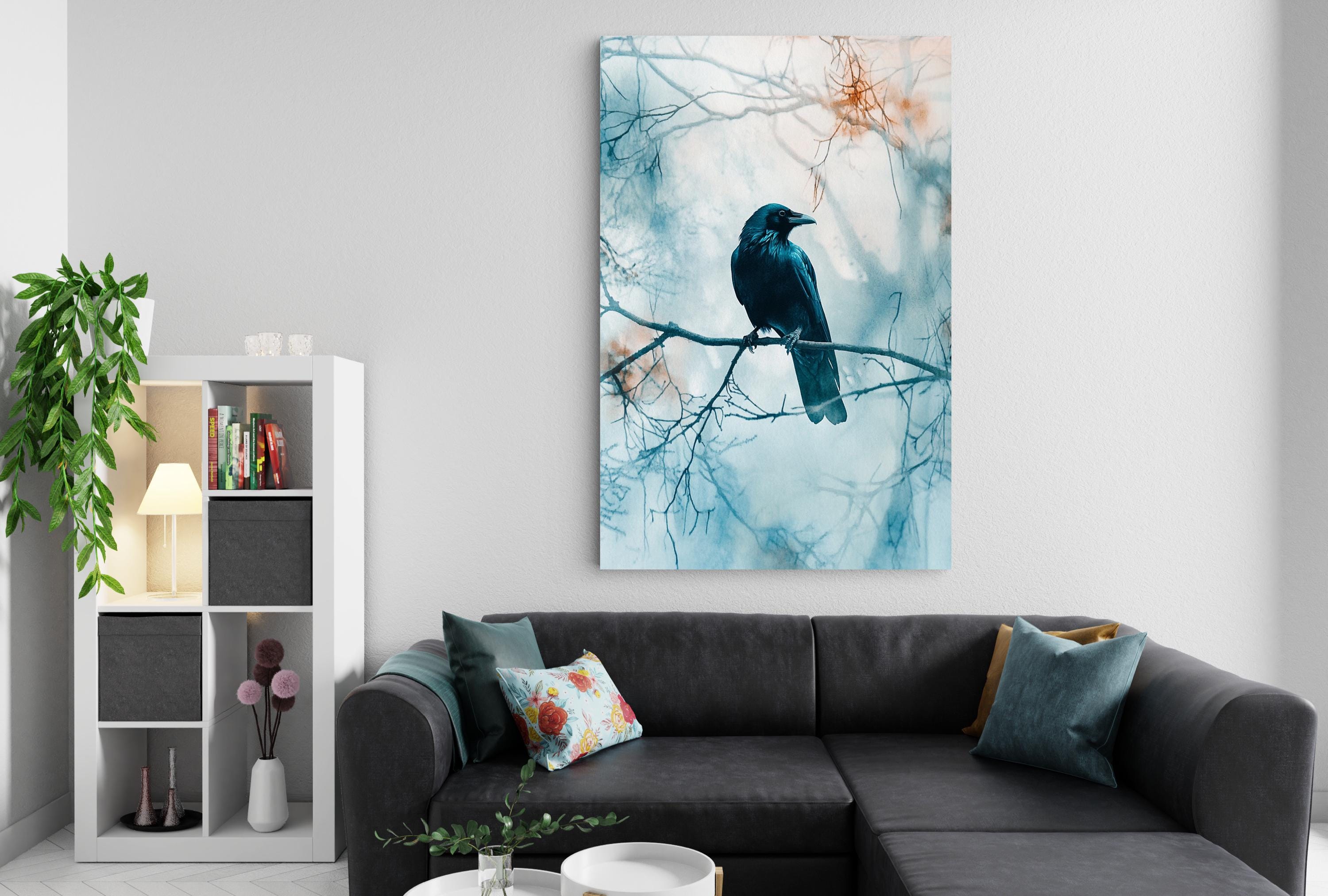 a cozy living room with a black couch, a bookshelf, and a large painting of a black bird perched on a branch.