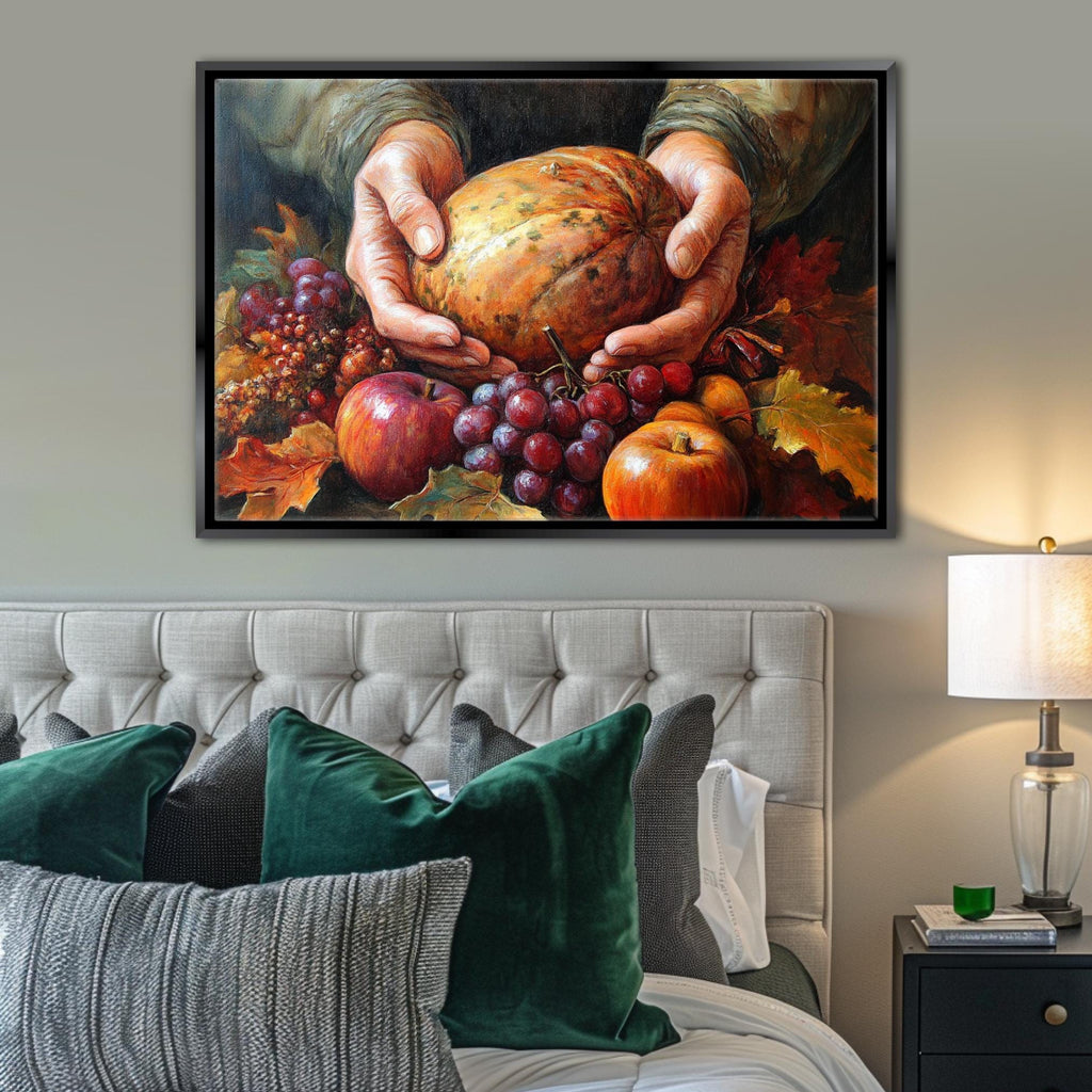A framed painting of a hand holding a pumpkin surrounded by various fruits, including apples, grapes, and an orange, is displayed on the wall above a bed with green pillows.