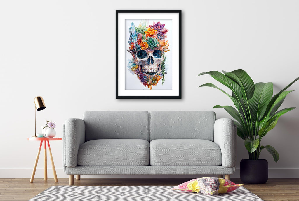 a gray sofa, a framed artwork of a colorful skull, a small table with a lamp, and a potted plant, all arranged in a living room setting.