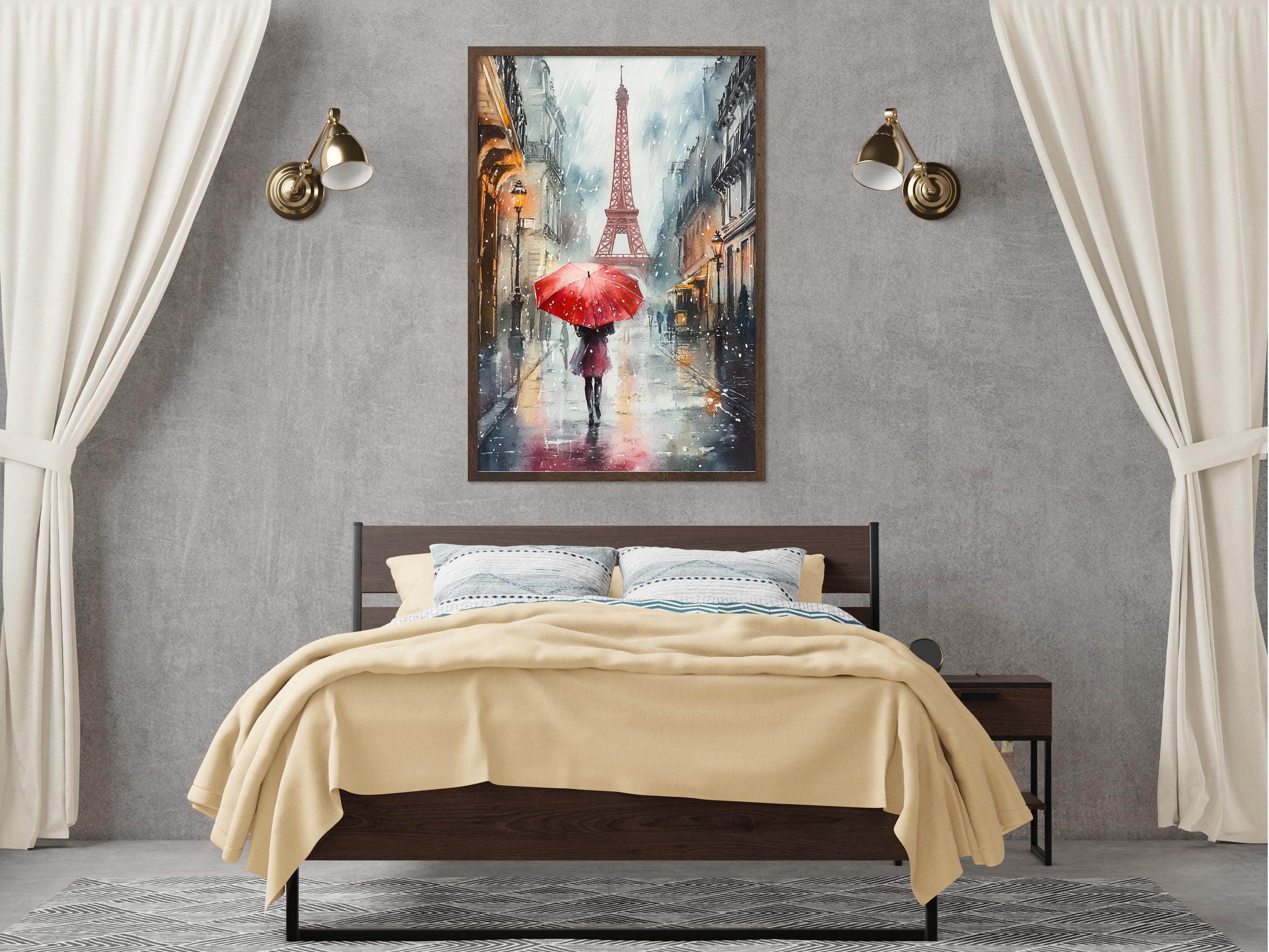 a bedroom with a large bed, a nightstand, and a framed painting of a woman holding a red umbrella in front of the Eiffel Tower.