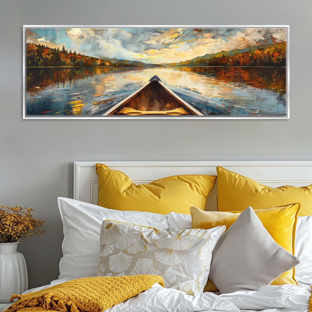 a large painting of a boat on a lake, with a scenic landscape in the background. The painting is displayed on a wall above a bed with yellow and white pillows.