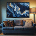 a living room with a couch and a painting on the wall