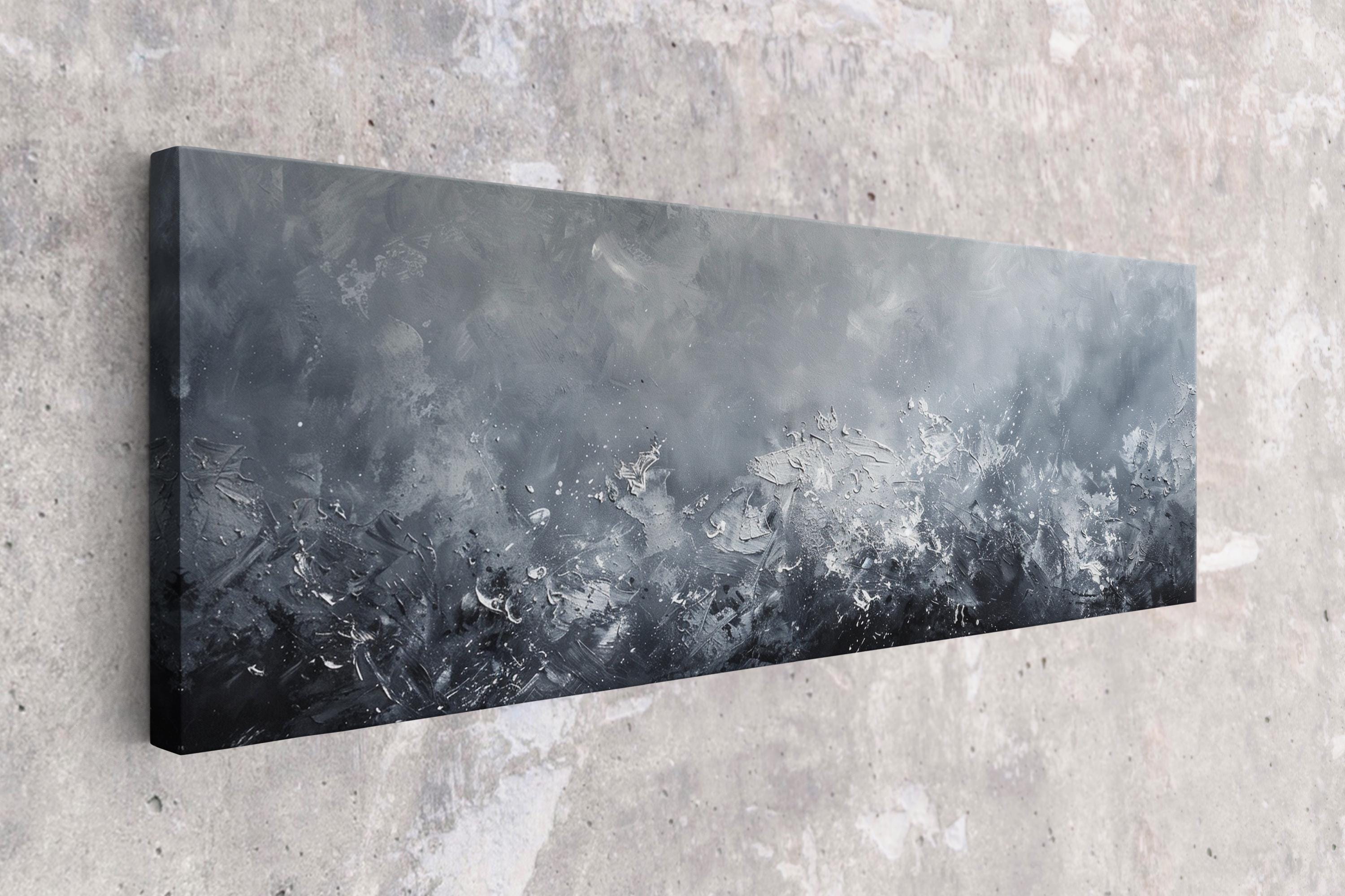 a black and white painting hanging on a wall