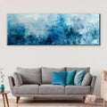 a living room with a couch and a painting on the wall
