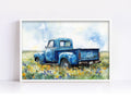 A blue vintage truck is parked in a field of wildflowers, with a cloudy sky in the background.