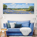 a living room with a blue couch and a painting on the wall