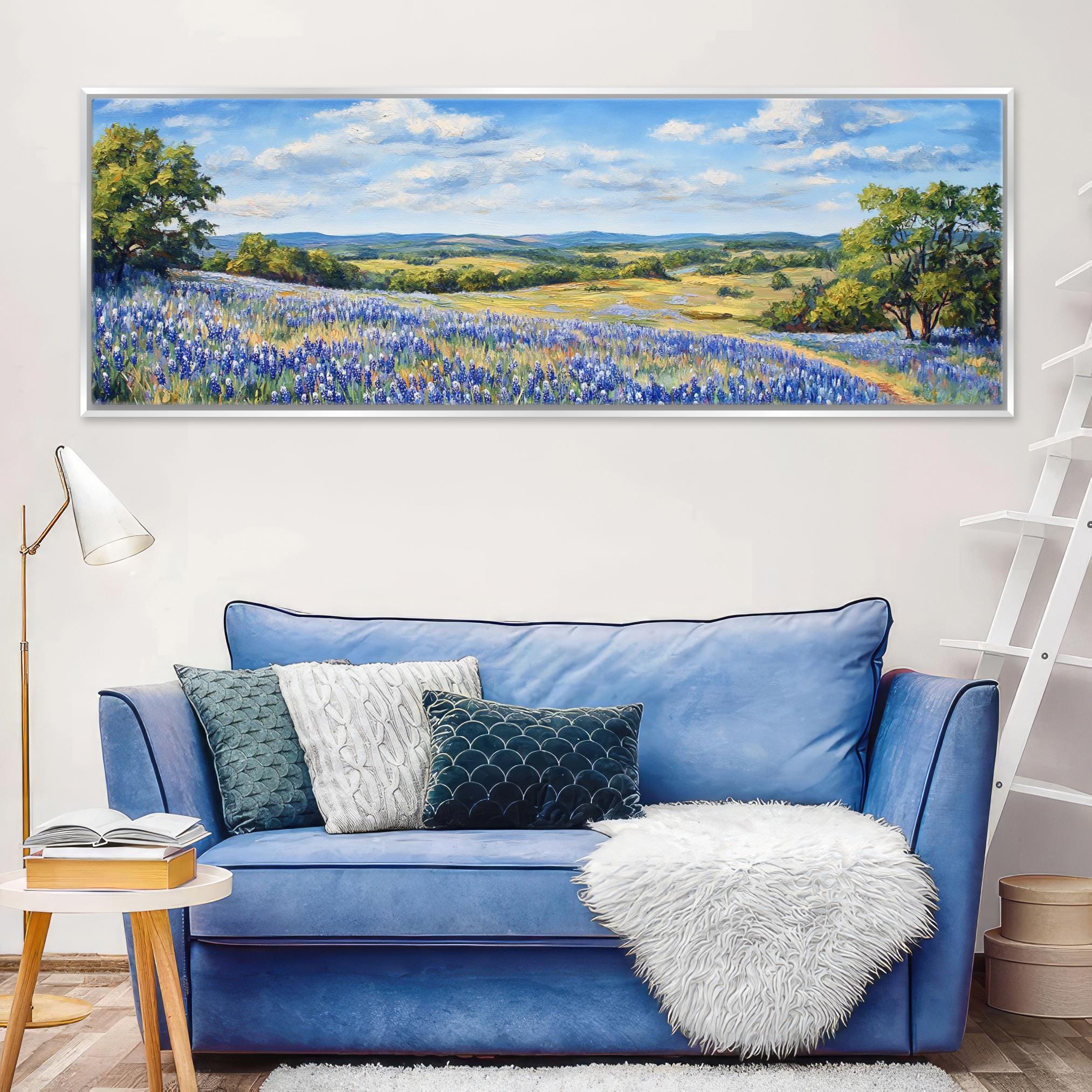 a living room with a blue couch and a painting on the wall
