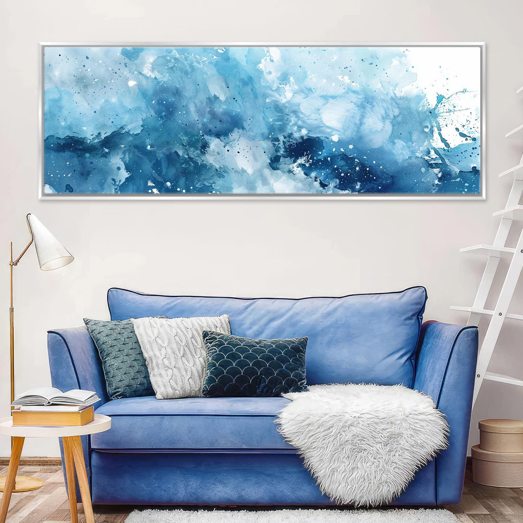 a living room with a blue couch and a painting on the wall