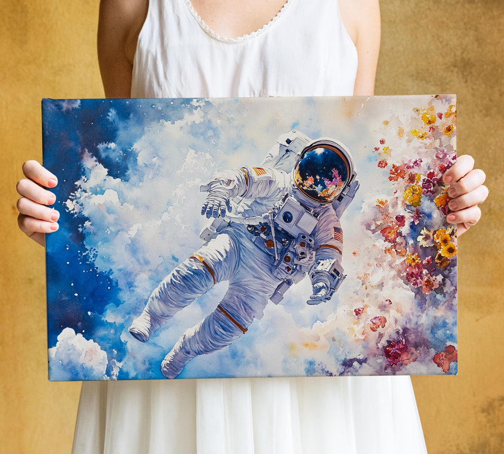 A person is holding a framed painting of an astronaut floating in space, surrounded by colorful flowers.
