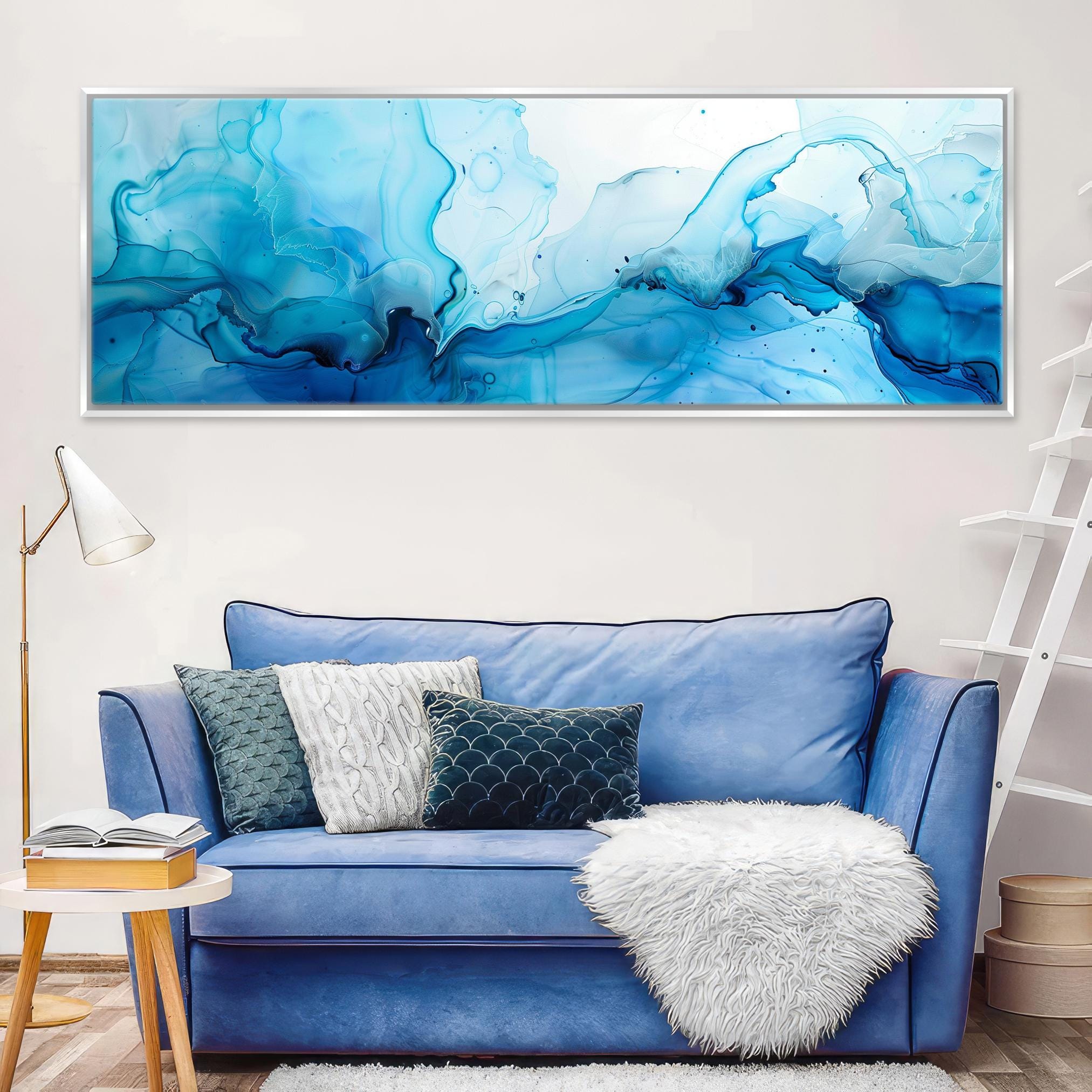 a living room with a blue couch and a painting on the wall