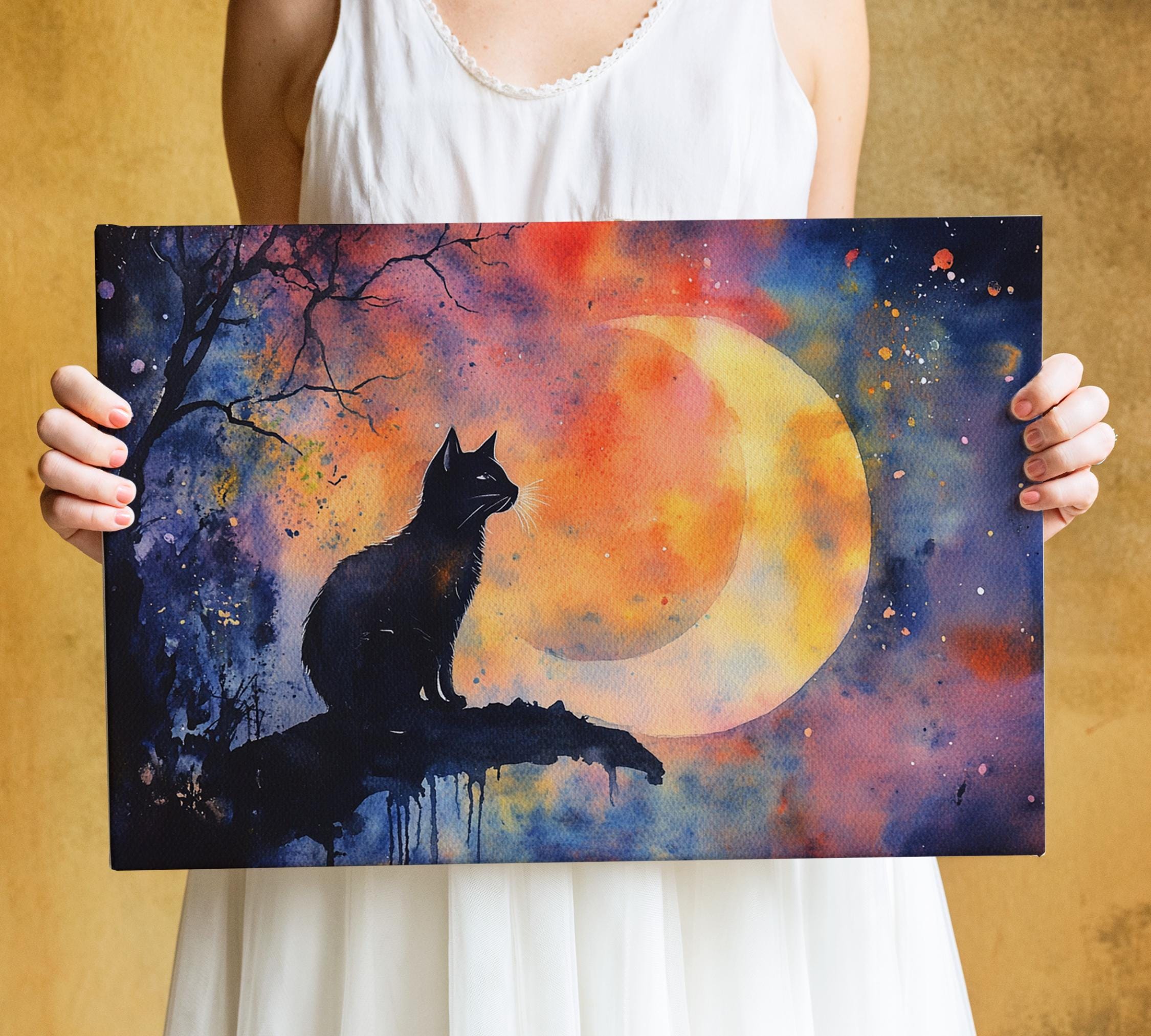 A person is holding a framed painting depicting a black cat sitting on a branch, with a crescent moon and colorful night sky in the background.