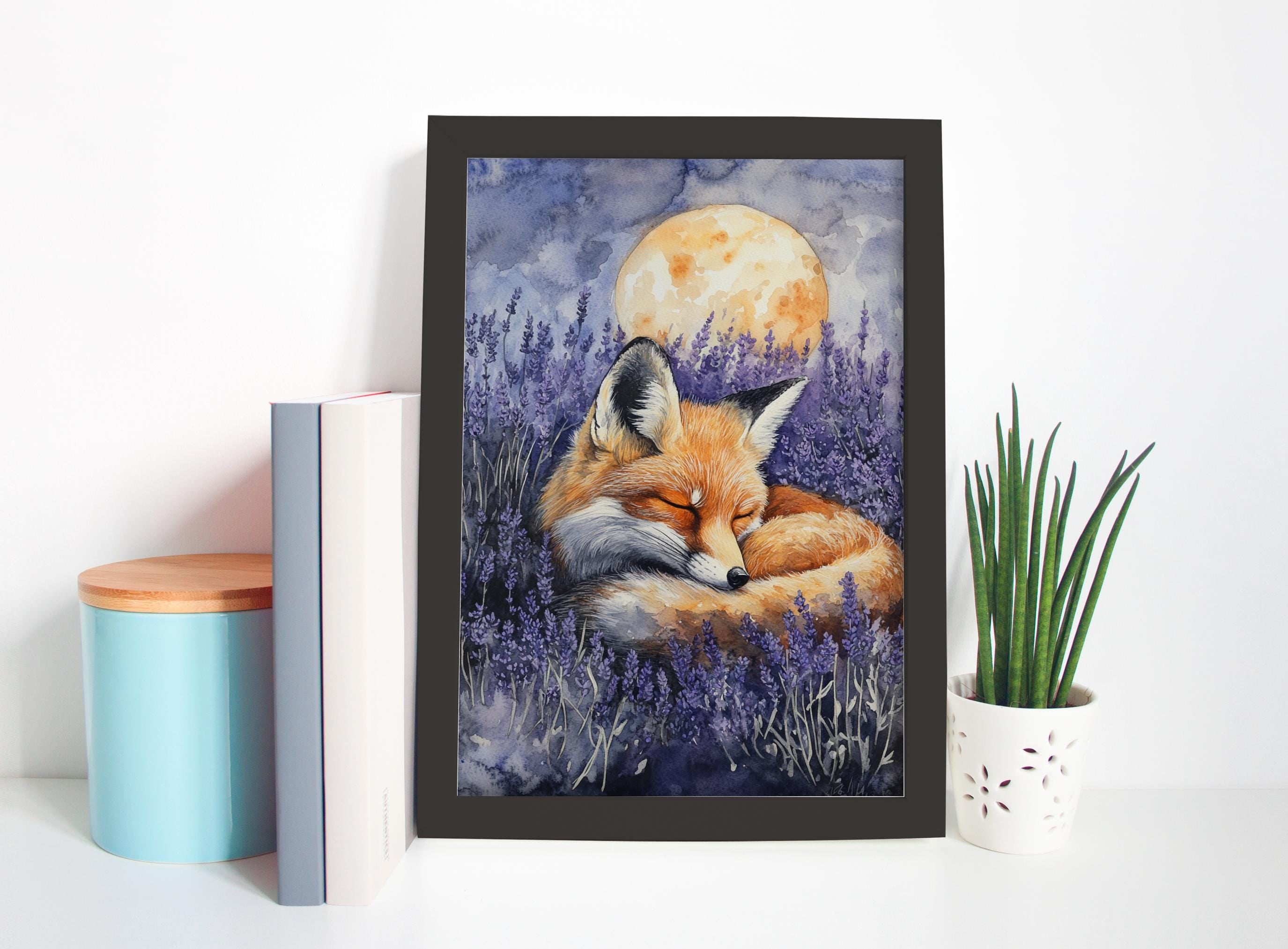 A framed painting of a sleeping fox is displayed on a shelf, surrounded by a blue container, a white vase with a plant, and a stack of books.
