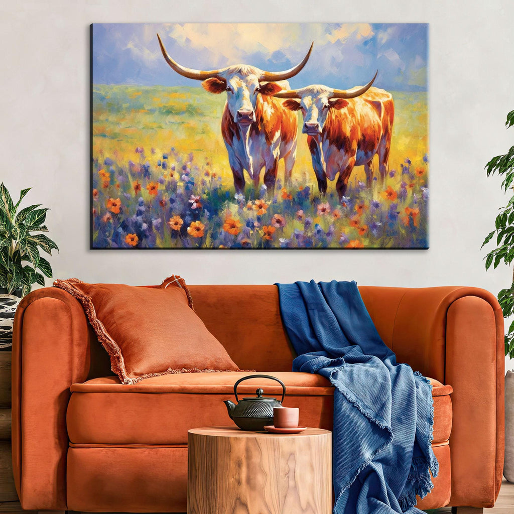 a large painting of two cows standing in a field of flowers, with a cozy living room setting below.