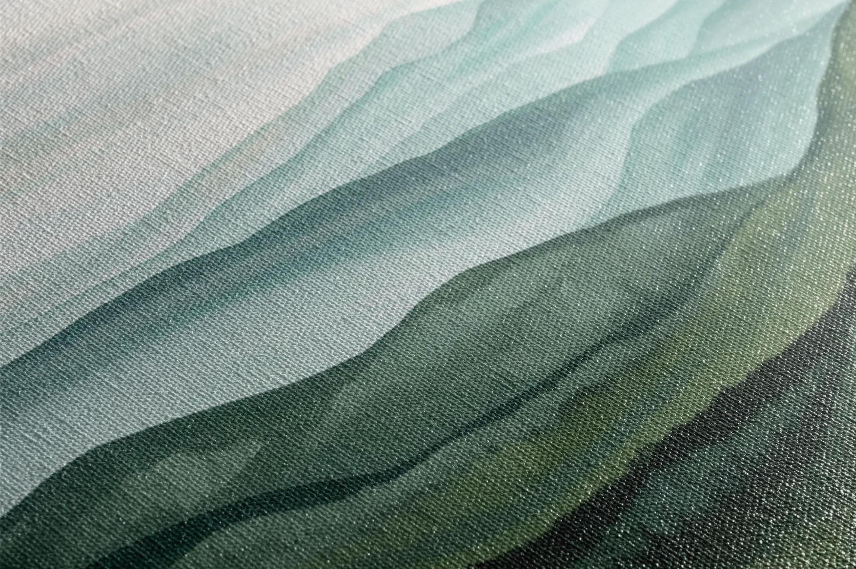 The image is a close-up of a textured surface with a gradient of green and gray colors, creating a visually interesting and abstract pattern.
