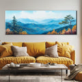 a living room with a yellow couch and a painting on the wall