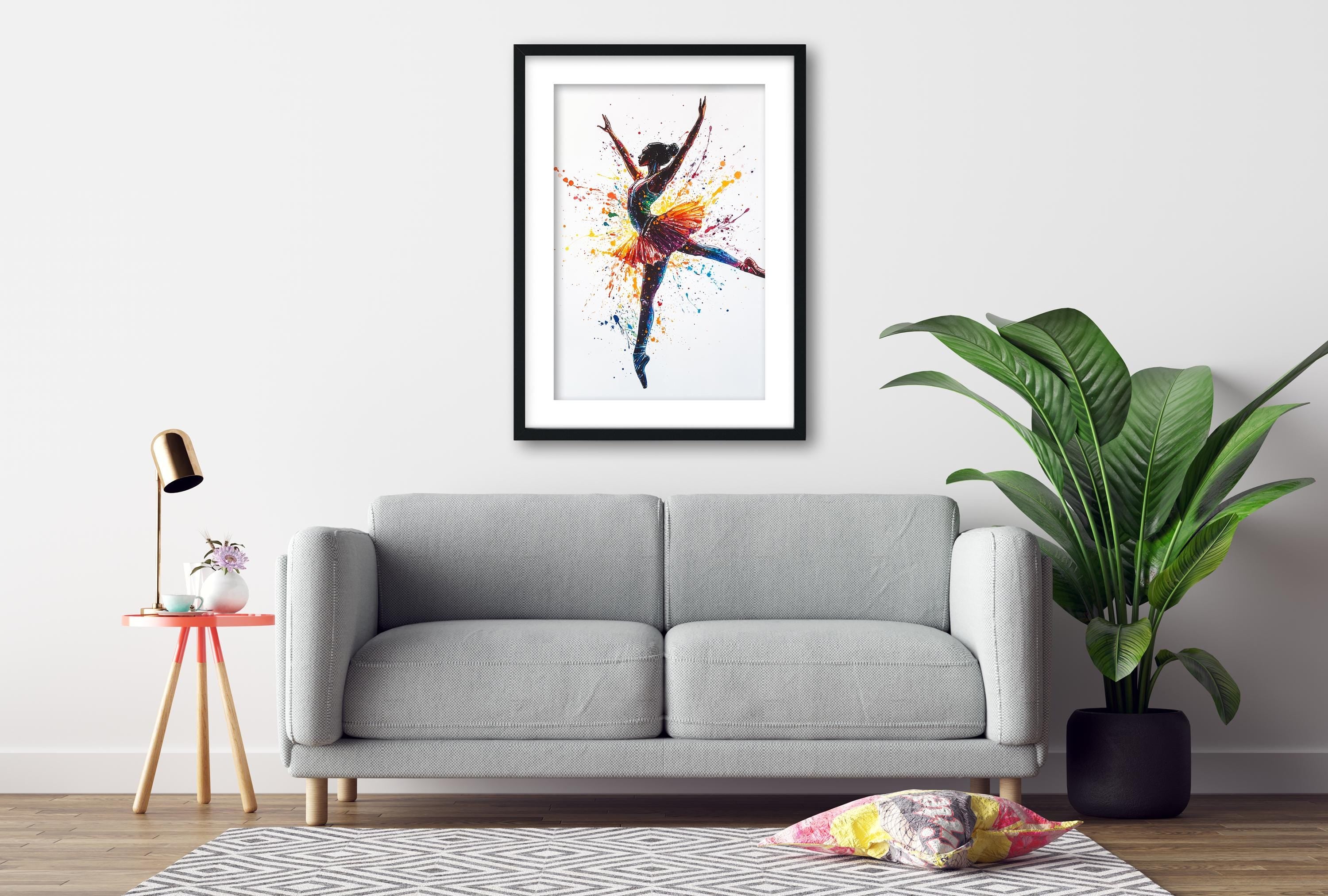 a gray sofa, a framed painting of a dancing figure, a small table with a lamp, and a potted plant, all arranged in a living room setting.