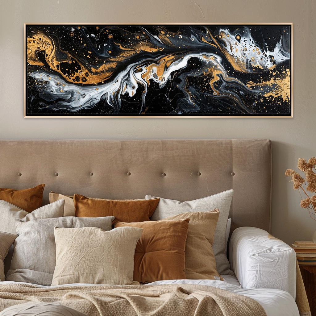 a bed with a large painting on the wall above it