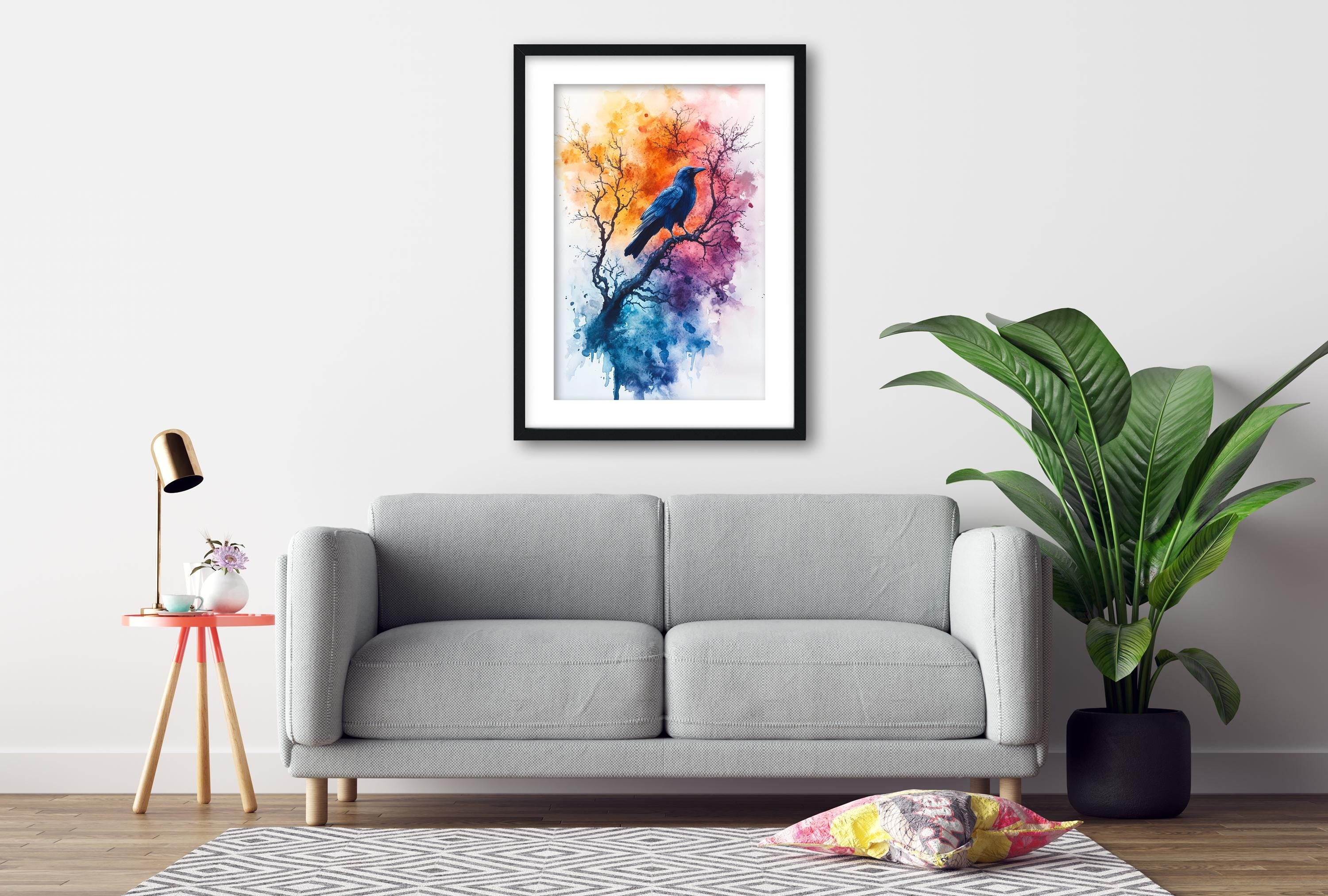 a gray sofa, a framed painting of a bird on a tree, a small table with a lamp, and a potted plant, all arranged in a living room setting.